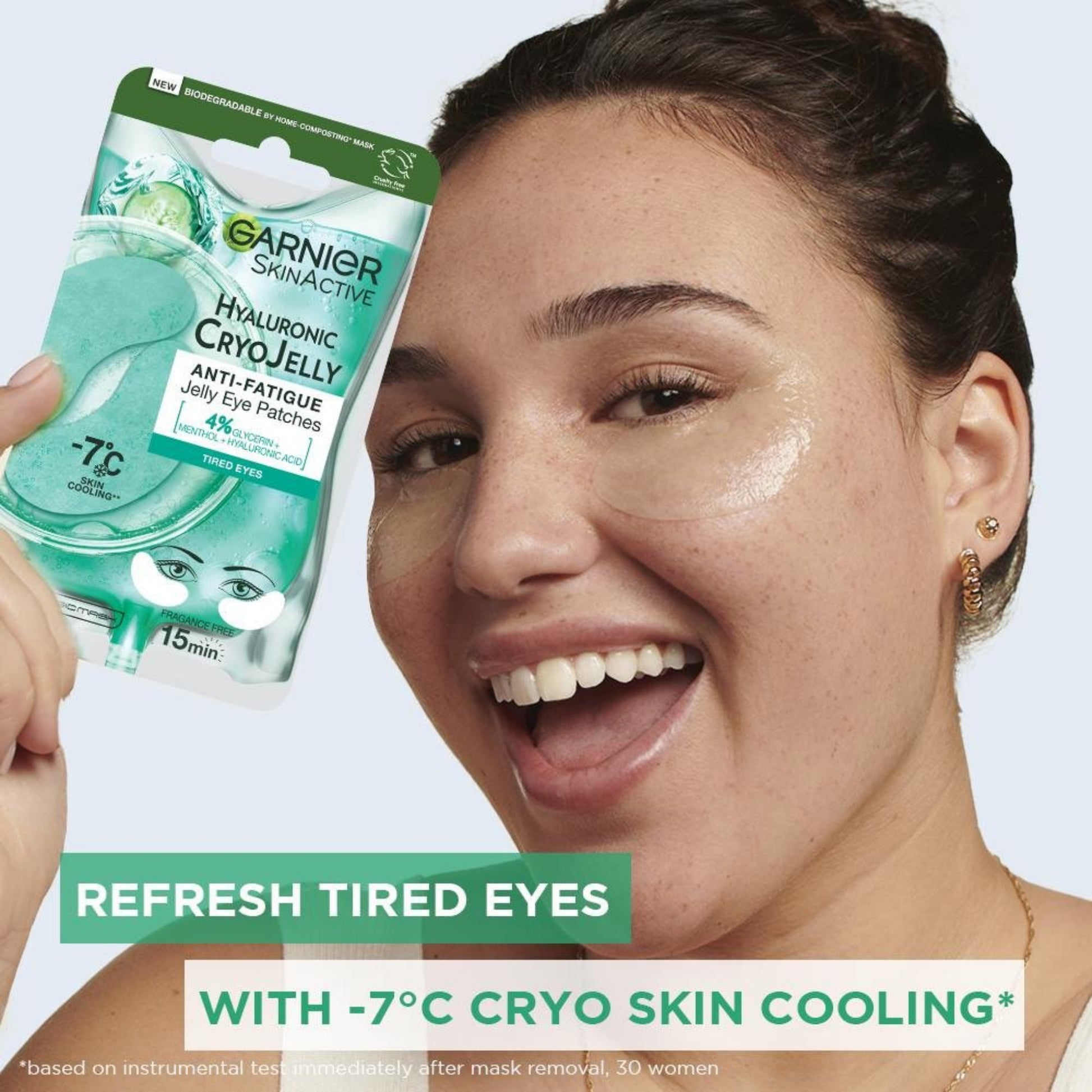 Woman holding Garnier Cryo Jelly eye patches with text on a light gray background
