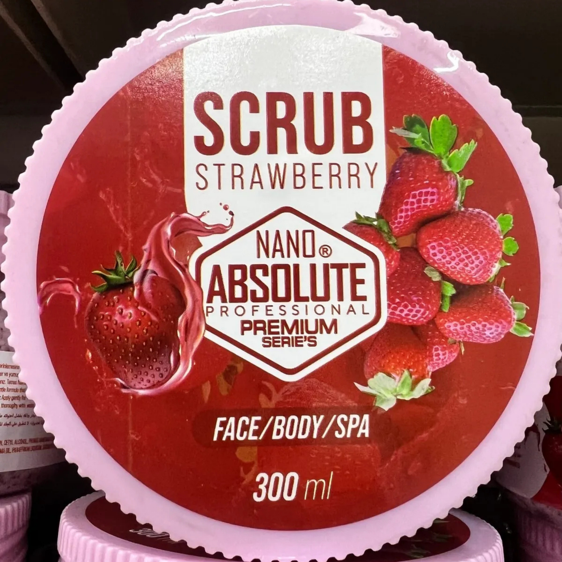 Strawberry scrub container with 'Absolute' branding on a red background